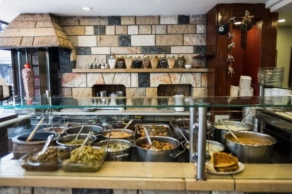 Buffet of traditional turkish dishes behind counter at Çiya restaurant, kadikoy, taste of two continents tour