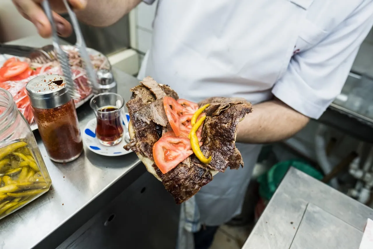 Doner kebab durum wrap rolled in lavash flatbread with tomatoes and pickles Istanbul