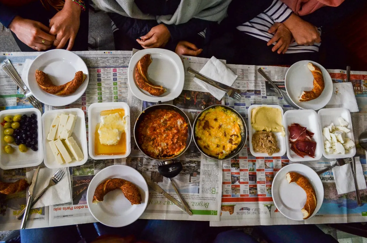 Taste of Two Continents starts with market breakfast of olives cheese eggs cream simit tea on newspaper