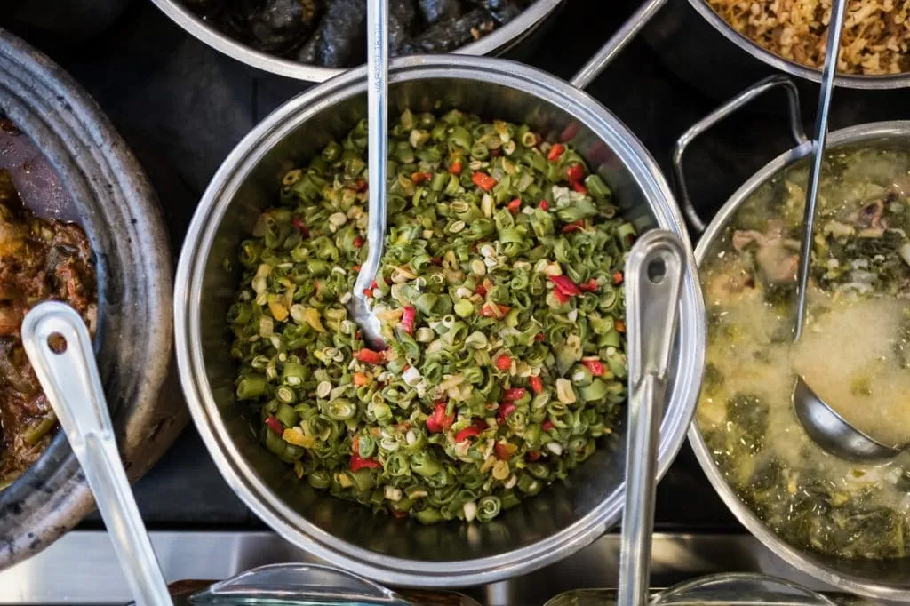 Large pot of cooked leeks dish among other Turkish dishes at Çiya restaurant, istanbul food walk