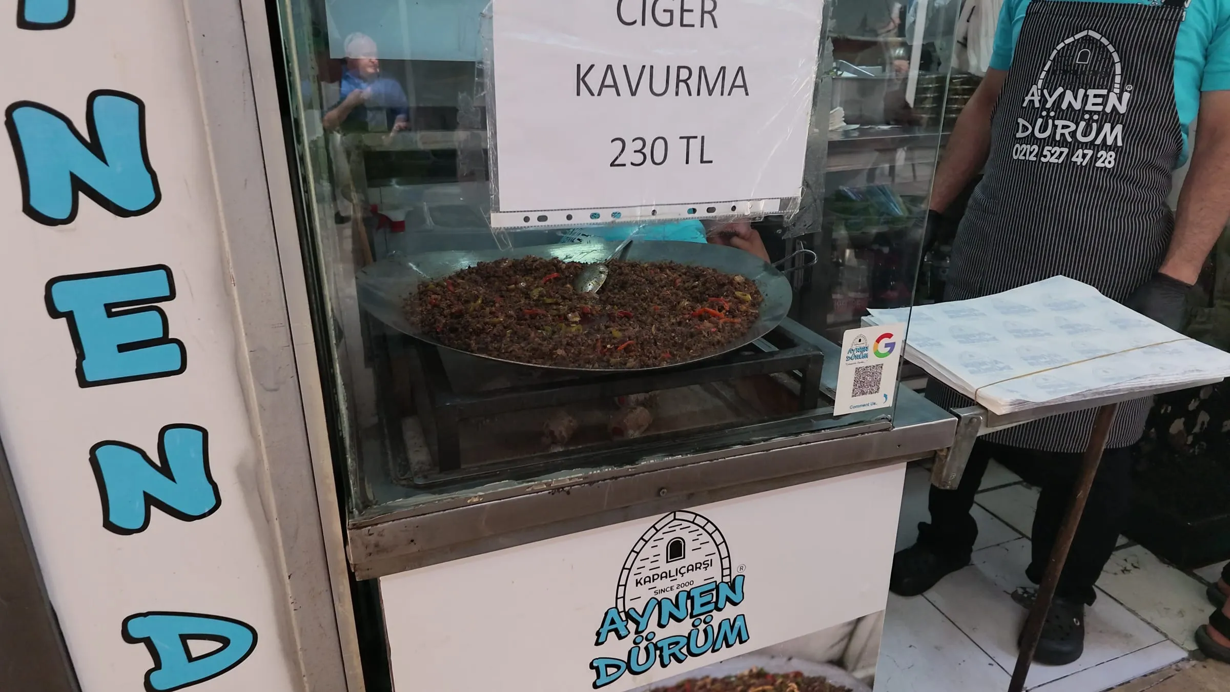 Ciğer kavurma cooking in a wide pan at the Aynen Dürüm counter inside the Grand Bazaar