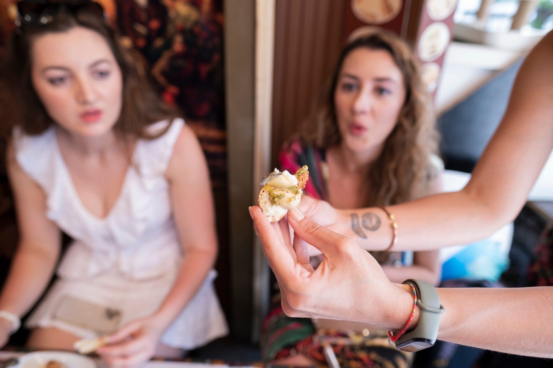 Guide showing a food sample to guests at a traditional Istanbul restaurant
