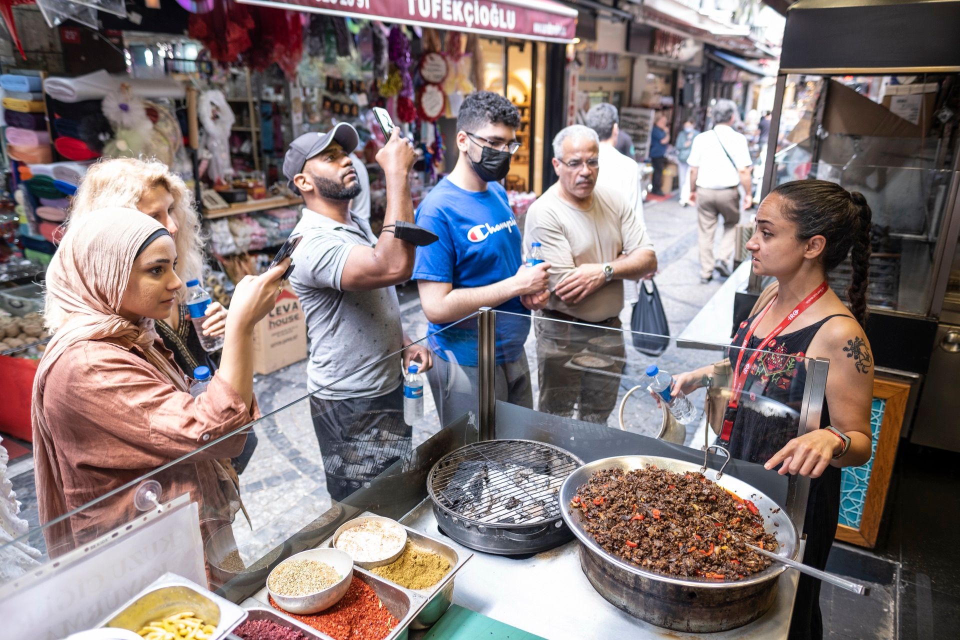 Guide at a street food stall with guests in Kadıköy market