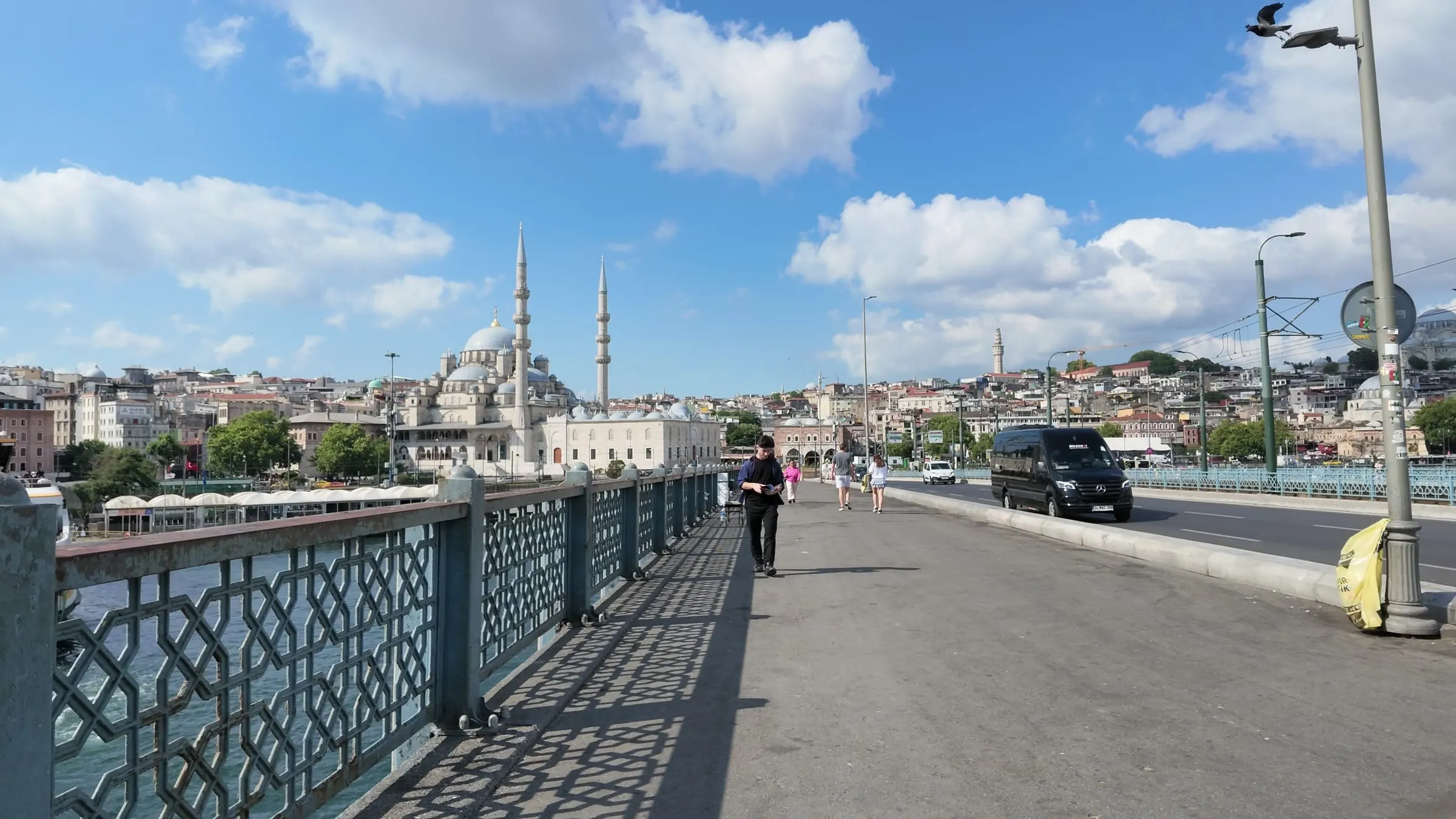 The pedestrian side of Galata Bridge leading toward Istanbul's historic peninsula skyline