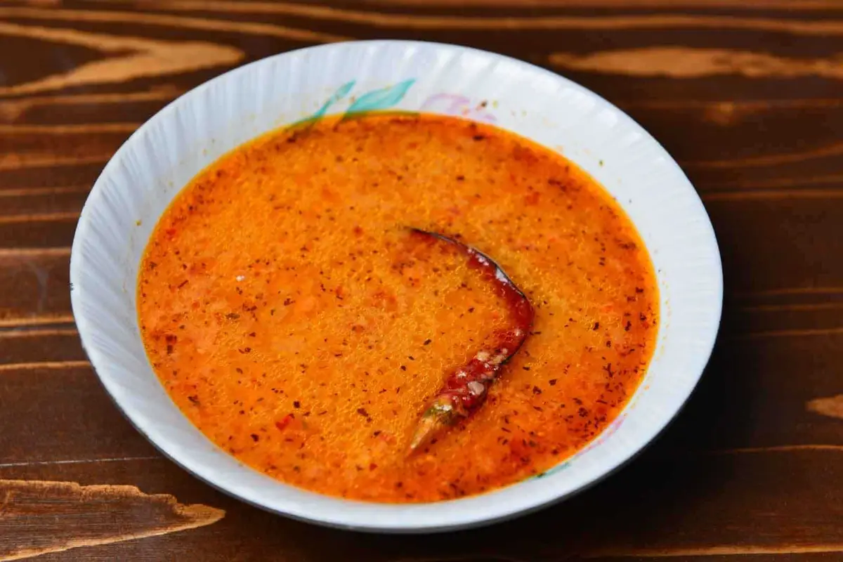 Tarhana soup in a bowl served with hot red pepper
