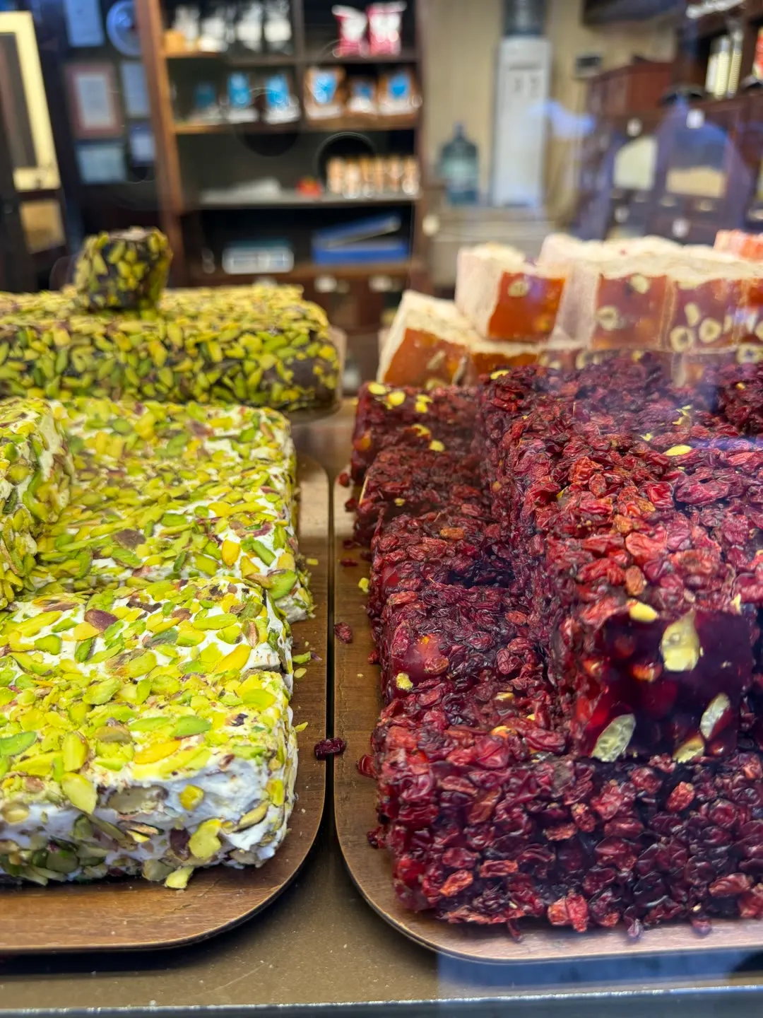 slabs of pistachio-crusted and barberry-studded lokum on wooden trays at a traditional Istanbul confectioner