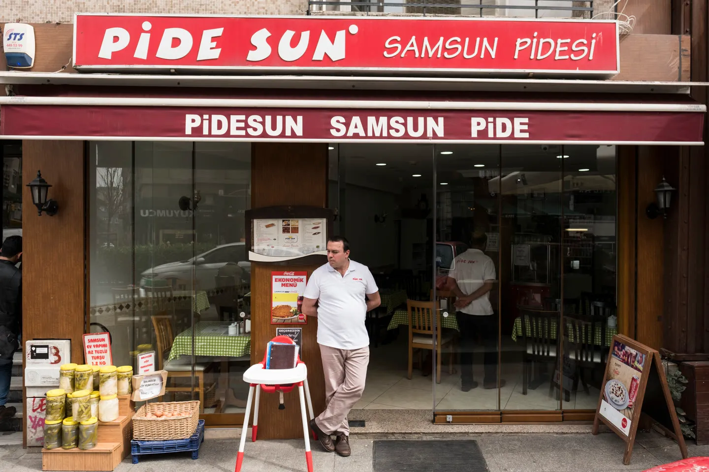 the red PIDE SUN Samsun pidesi storefront with pickle jars stacked outside