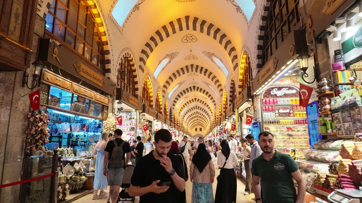 the vaulted painted ceiling of the Spice Bazaar above shopfronts selling saffron, sweets and copper
