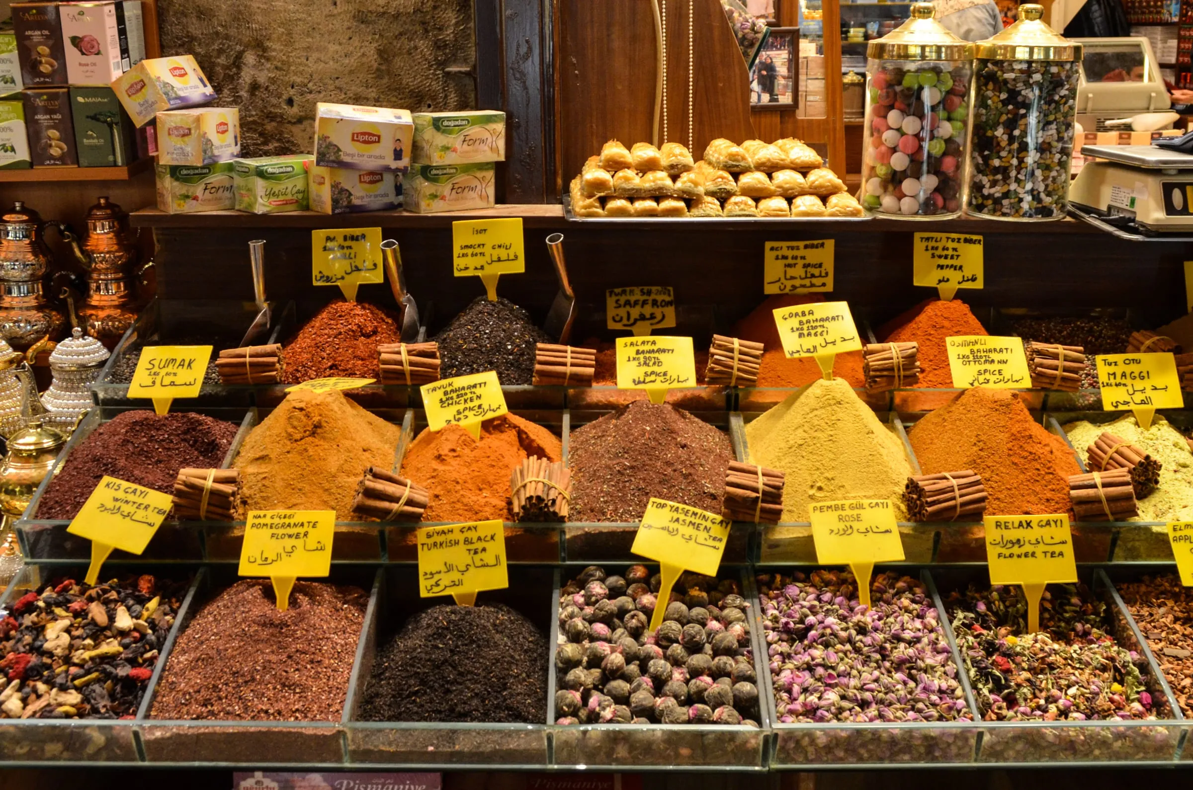 Spice Bazaar counter with pyramids of red pepper flakes and handwritten signs for isot and pul biber