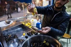 Street stall midye dolma: mussels stuffed with spiced rice, served in the shell with lemon