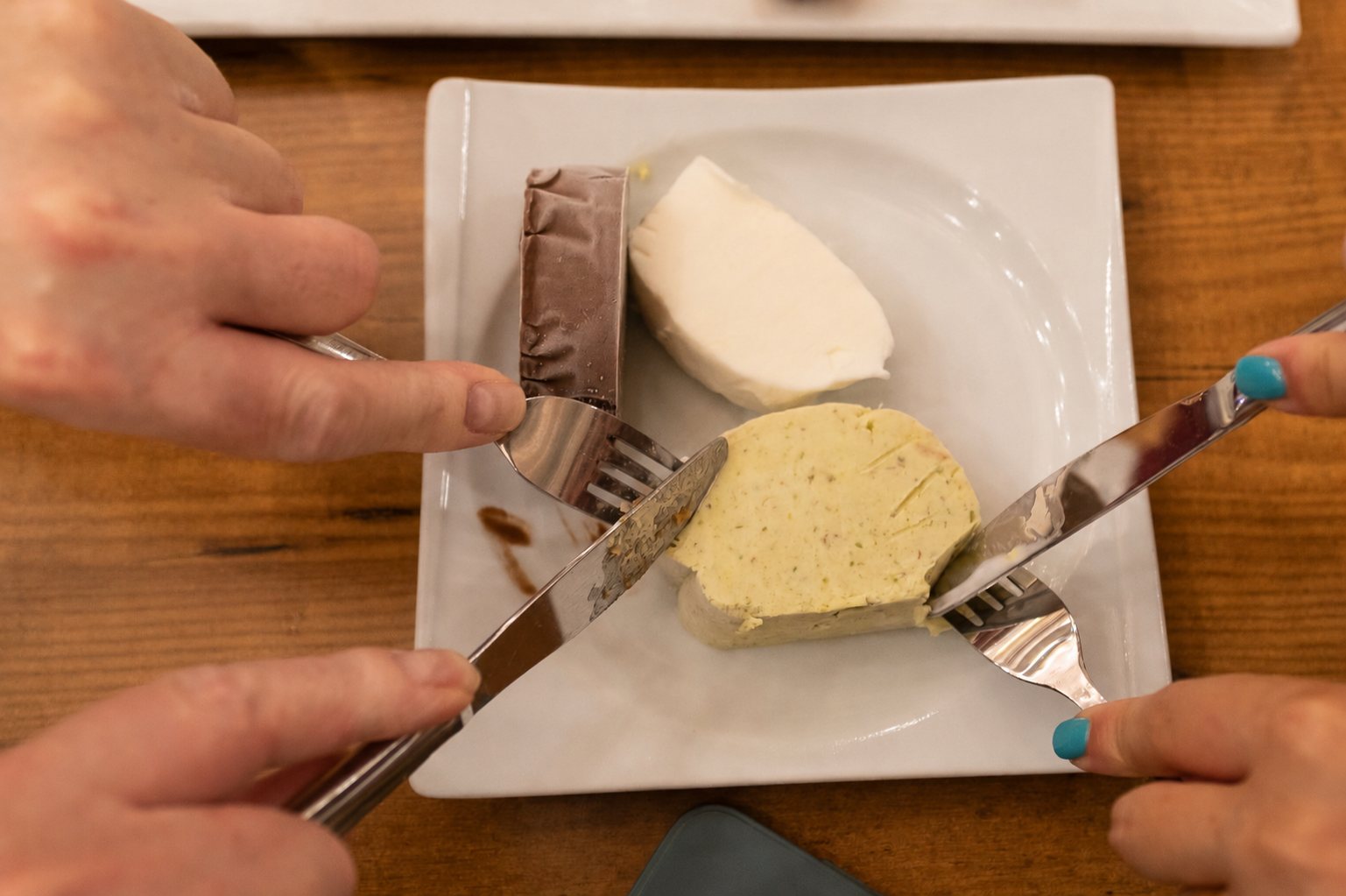 Three scoops of Turkish dondurma (pistachio, chocolate and vanilla) shared between guests with knives and forks